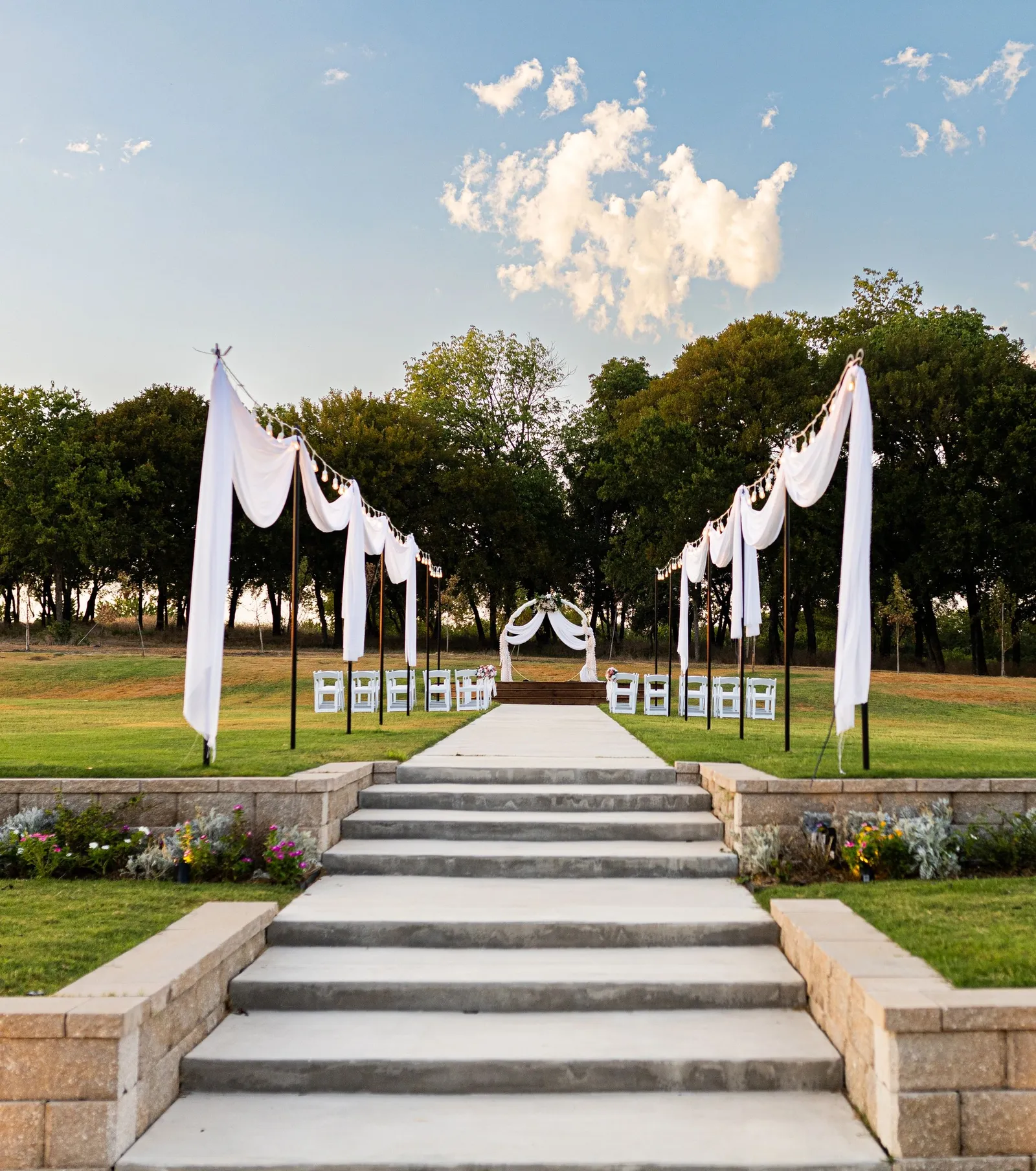 Outdoor ceremony with white chairs on the lawn at Primrose Hill near Sherman, Texas